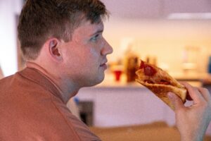 man eating pizza